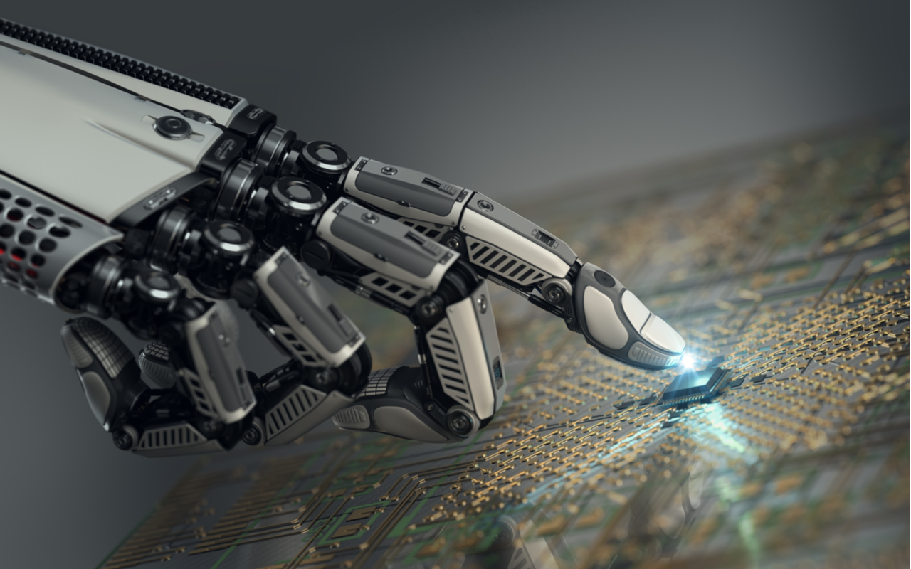 robot hand pointing to a computer chip