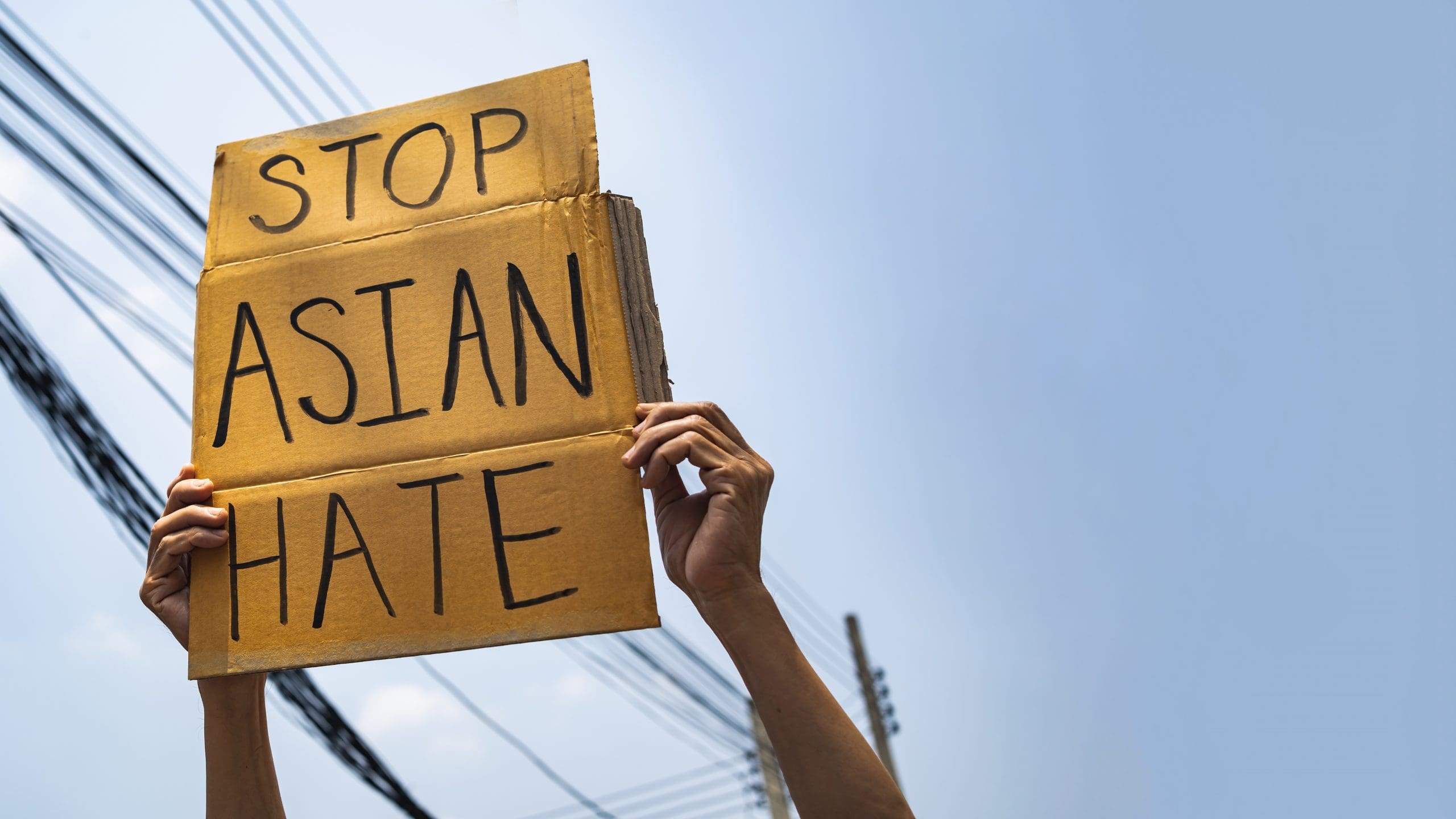 A man holding Stop Asian Hate sign
