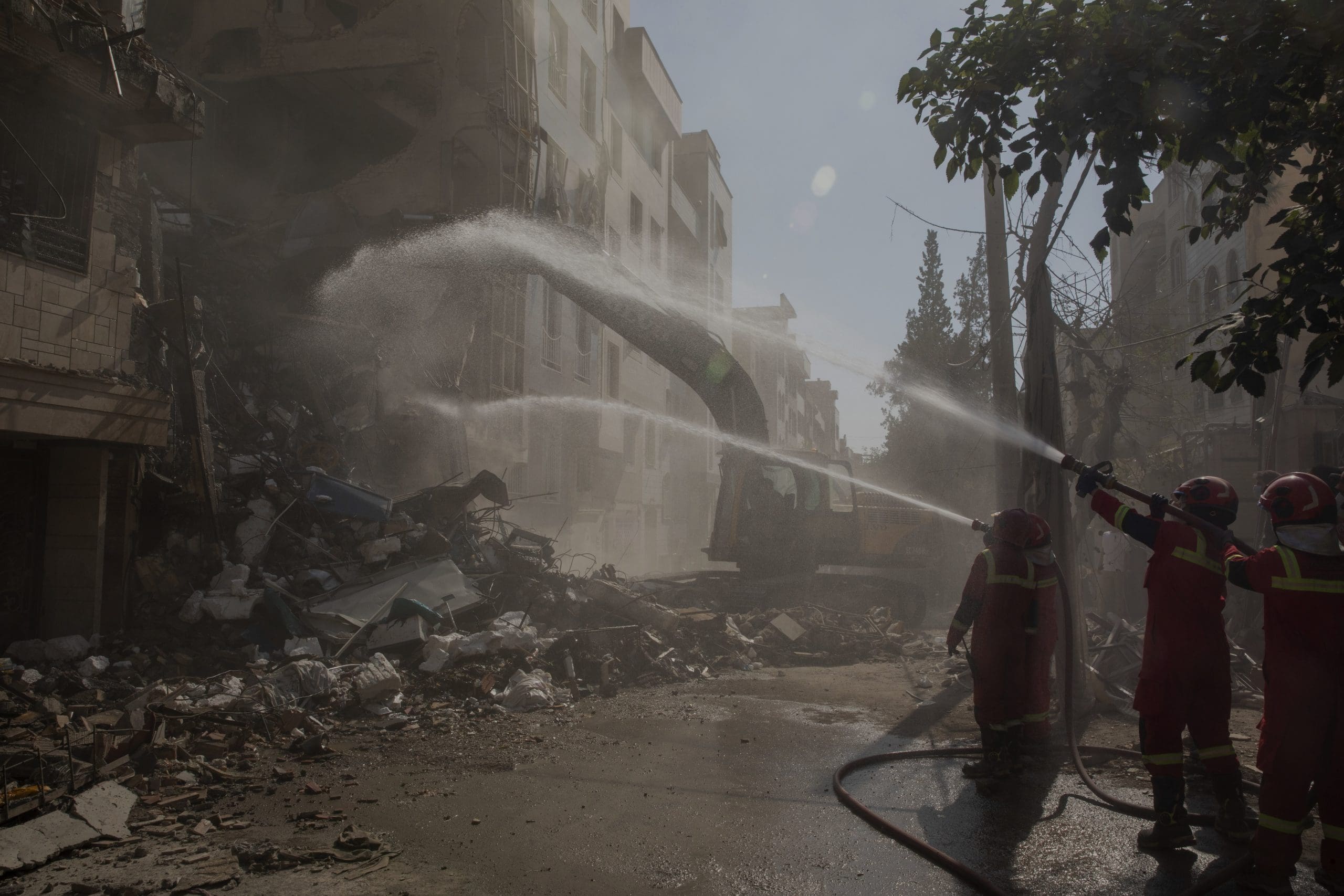 Firefighters extinguish a fire in a building that was destroyed in an Israeli attack on June 13, 2025 in Tehran, Iran. Early this morning, Iran was hit by a series of Israeli airstrikes targeting military and nuclear sites, as well as top military officials.