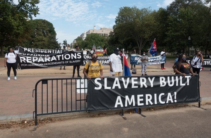 Demonstrators call for reparations at the White House (Shutterstock)