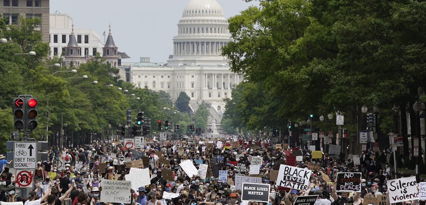 Photo of a large group of protesters with the U.S. Capital Building in the background
