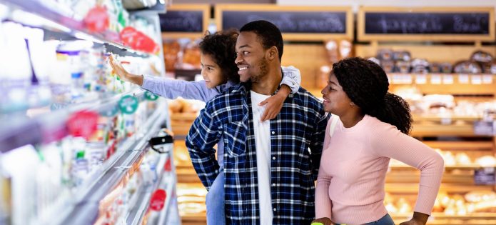 A family browses goods at a grocery store.